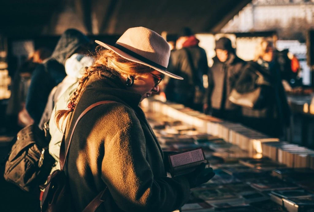 Woman at Booksellers Stall Photo Courtesy of Clem Onojeghuo on Unsplash